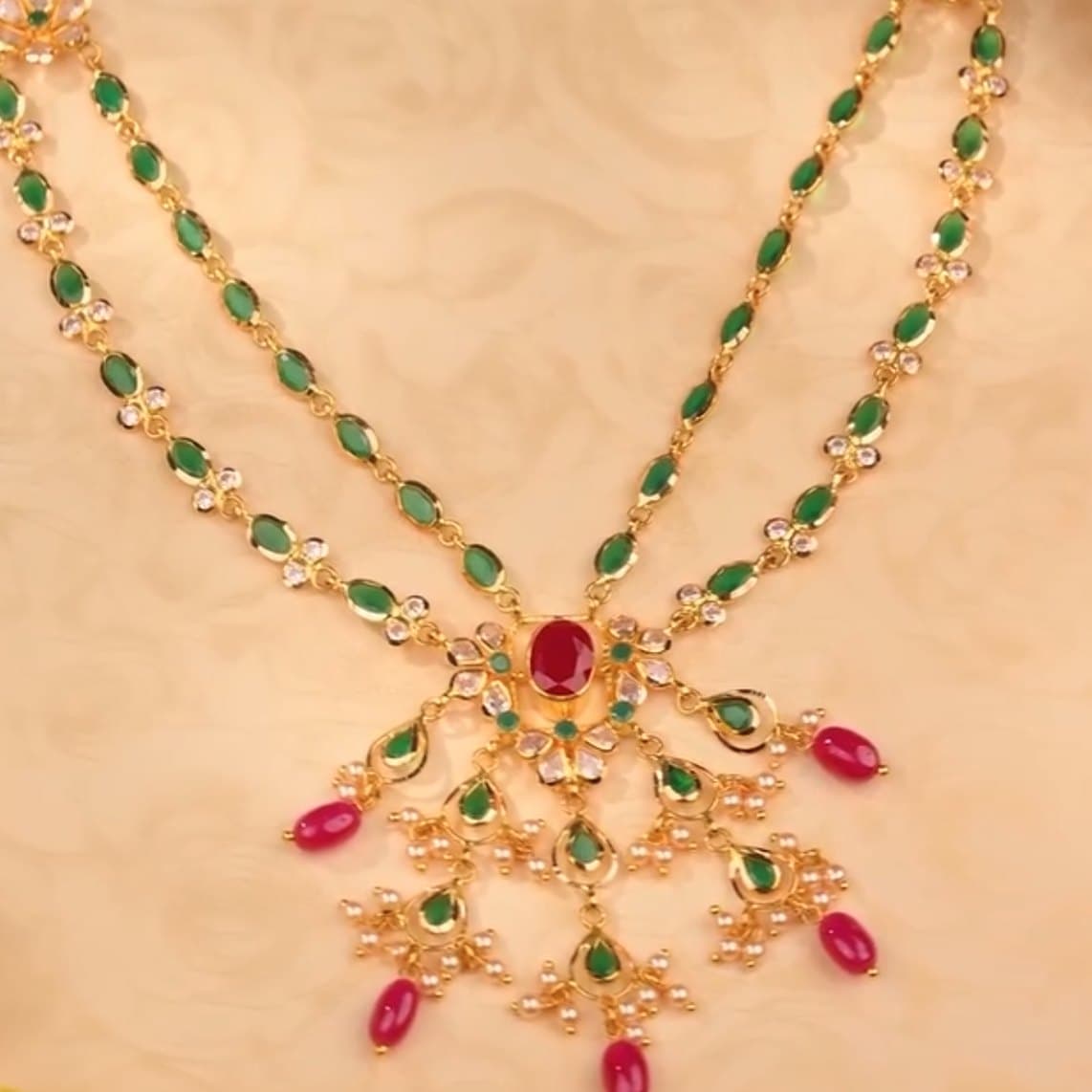 Close detail of a ruby and emerald pendant
